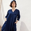 The model is wearing a navy dress.