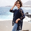 The model is wearing a dark blue patterned cardigan.