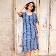 The model is wearing a navy dress.