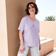 The model is wearing a purple shirt.
