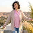 The model is wearing a beige cardigan.