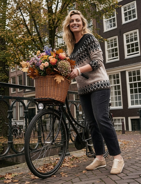 The model is wearing a cozy sweatshirt.