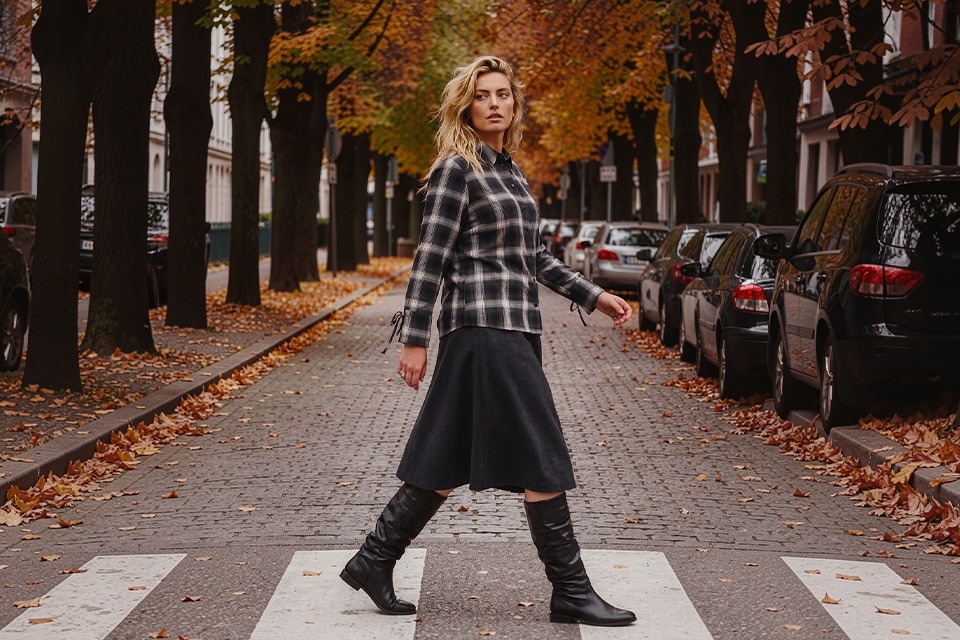 The model is wearing a blouse and a skirt.