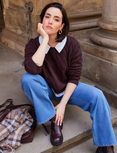The model is wearing a cozy sweatshirt.