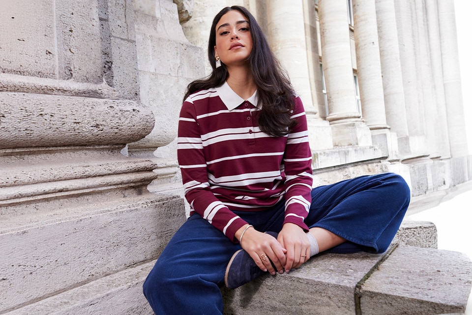 The model is wearing a shirt with stripes
