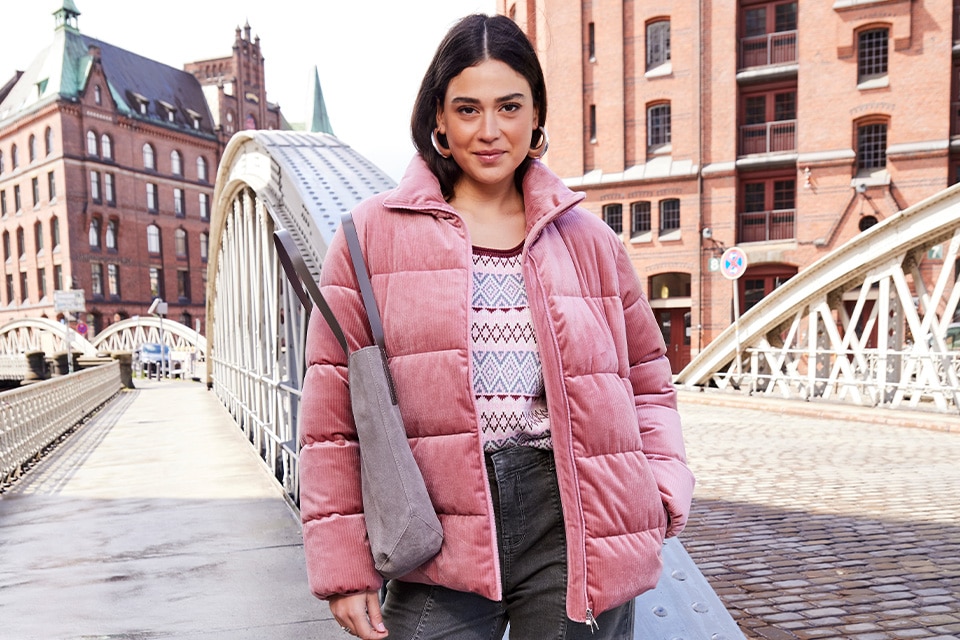 The model is wearing a Pink jacket