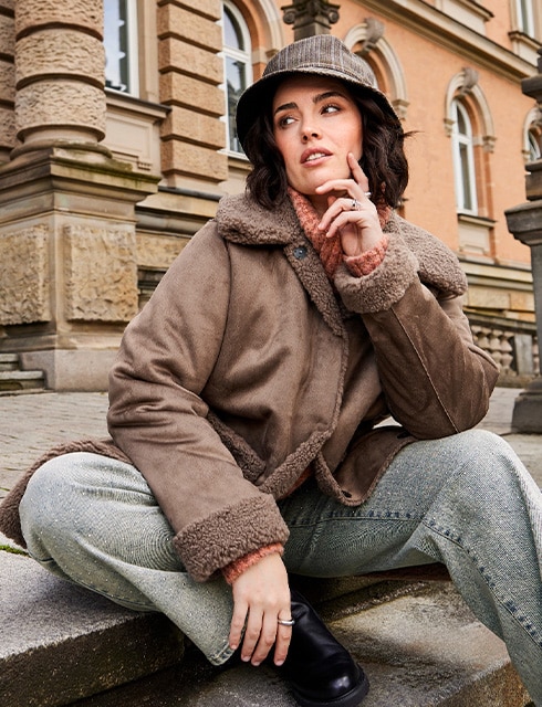 The model is wearing a cozy jacket.