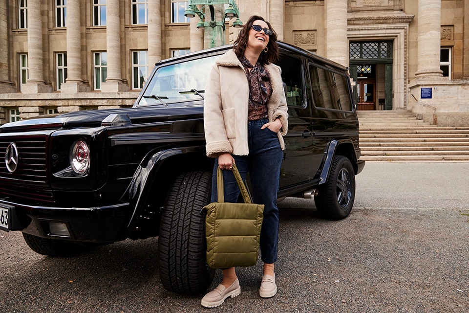 The model is wearing a beige jacket.