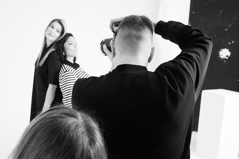 Photographer in a photo studio with two models