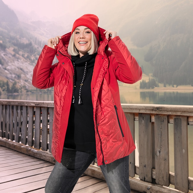 The model is wearing a beige softsell long jacket