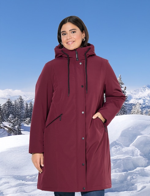 The model is wearing a black functional jacket