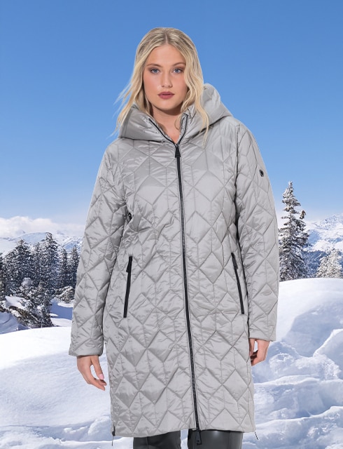 Woman with sweat jacket standing on an footbridge