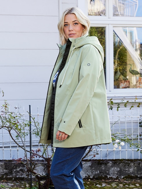 The model is wearing a pastel green Jacket.