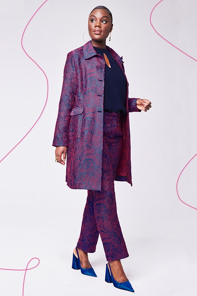 Model wearing a purple blazer and purple pants.