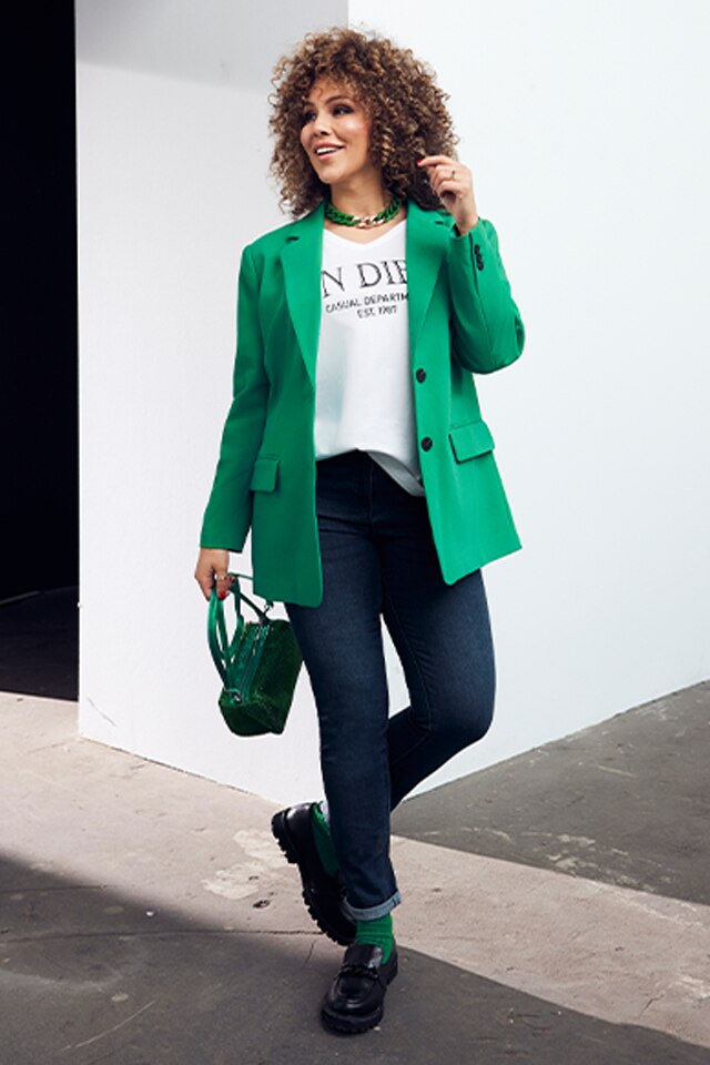 Model wearing a green blazer.