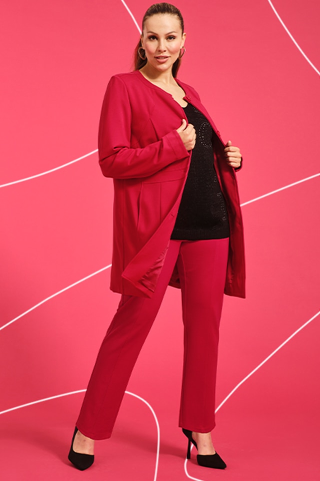 Model wearing a red blazer and red pants.