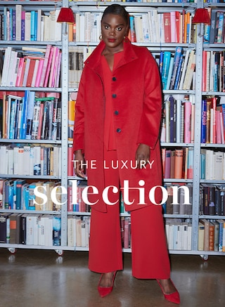 The model poses in a red blouse and a red coat from Selection 