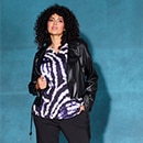 The model wears a black leather jacket over a pure patterned blouse