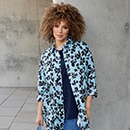 The model is wearing a patterned long blouse