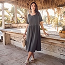 the model wears a dark sweat dress