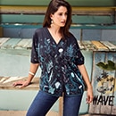 the model wears a blouse with decoration
