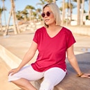 the model wears a pink shirt