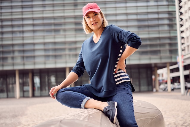The model poses in a blue  blouse                

