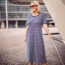 the model wears a dress with stripes		

