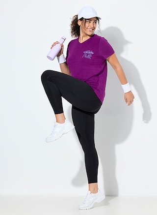 The model poses in a sporty collection 		

