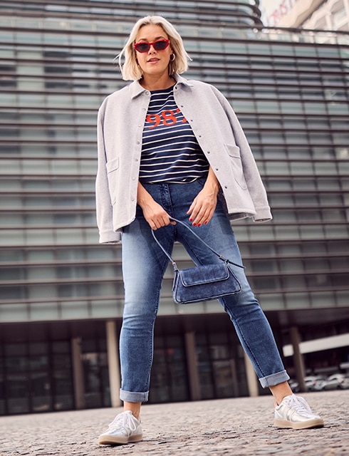 the model wears a striped sweater and a jacket			

