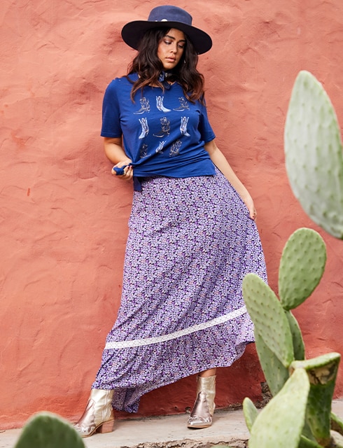 the model wears a sja jacket and a skirt