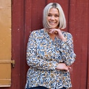 the model wears a blue blouse