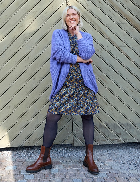 the model wears a dress and a cardigan
