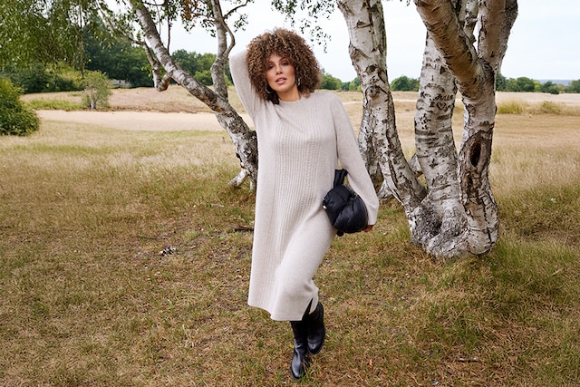 The model wears a beige jacket