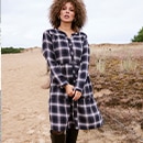 the model wears a checked dress