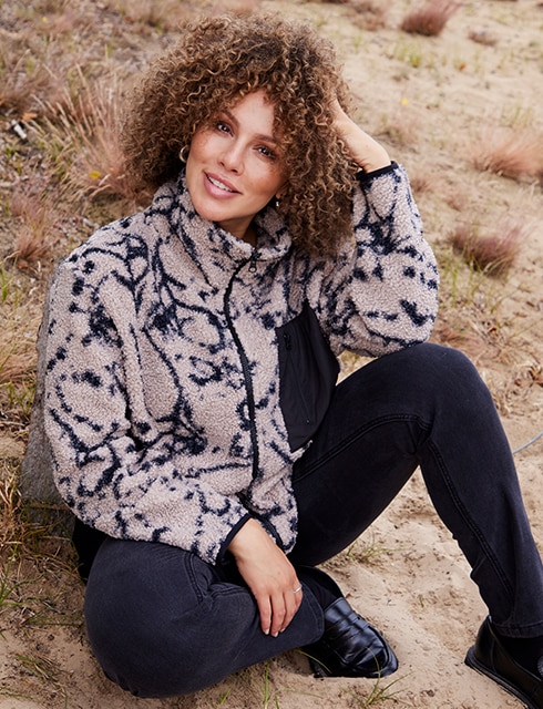 the model wears a beige Jacket