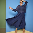 the model wears a blue dress