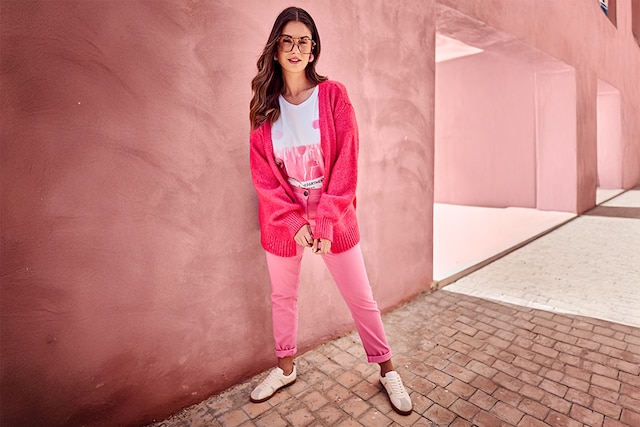 The model wears a pink dress