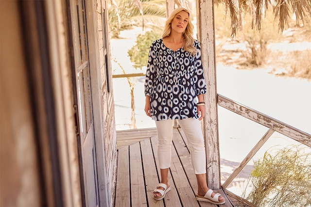 The model wears a blue blouse