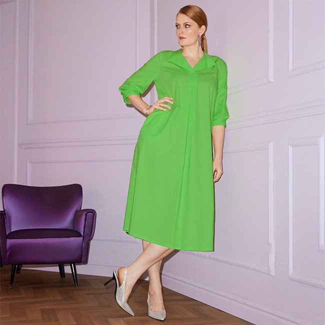 the model wears a green dress