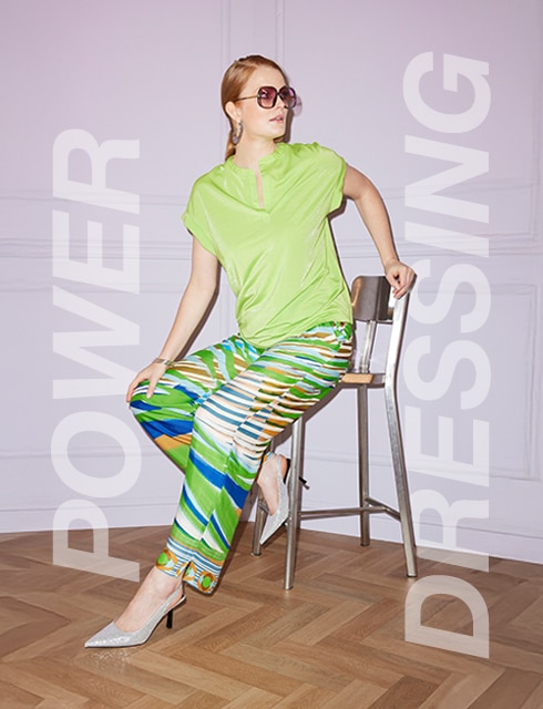 Three models pose in different outfits, suitable for the office.