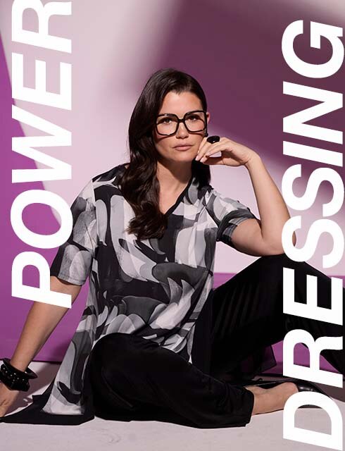 a model is wearing a blouse and black pants