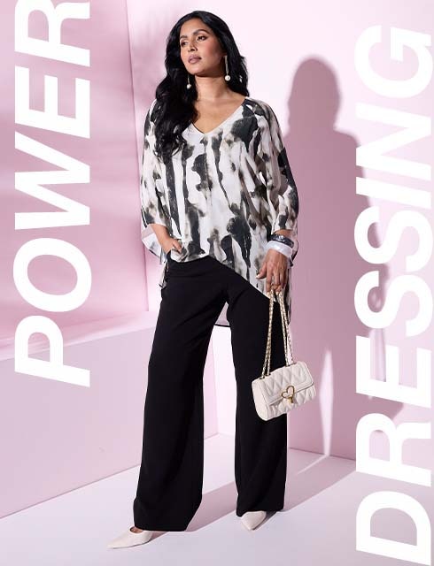 a model is wearing a blouse and pants