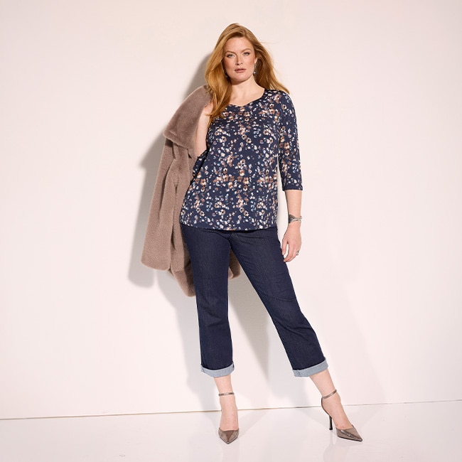 the model is wearing a colorful blouse