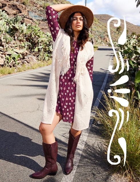The model wears a red dress with knitwear and awesome red cowboy boots.