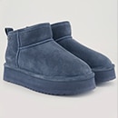 A pair of boots in green suede 
