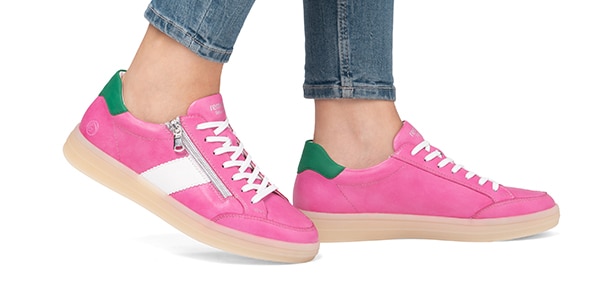 A pair of pink sneakers with green and white accents