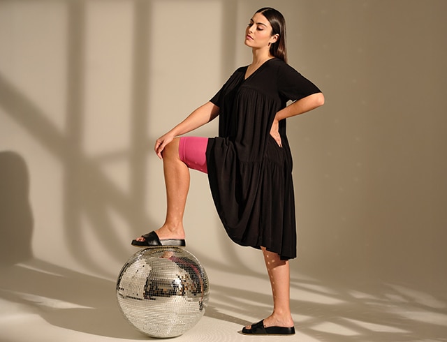 The model poses sitting in black non-see-through tights thermal function