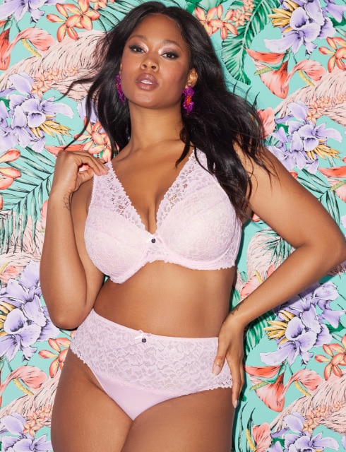The model is wearing a black bra with playful details