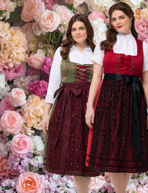 Two models pose in the same dirndl. One model wears a beige apron, the other model a dark blue apron